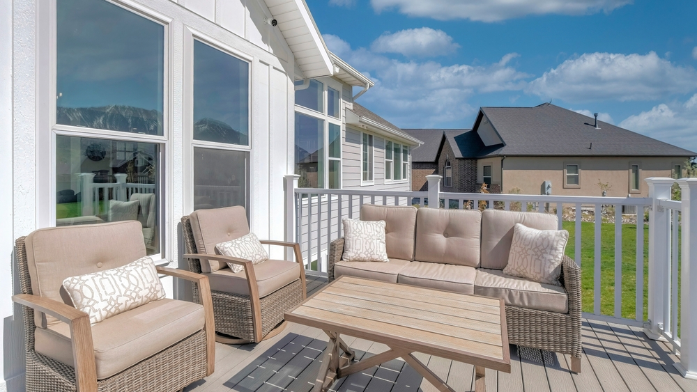Panorama,white,puffy,clouds,outdoor,patio,on,a,wooden,deck