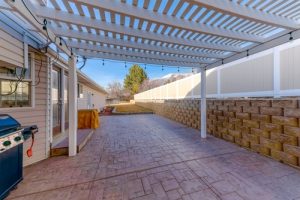 Pergola,roof,with,stringlights,above,the,stone,tiles,ground,at