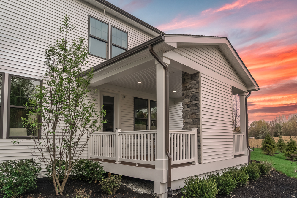 Outdoor,patio,or,sunroom,with,white,railing,,dark,gutters,,white